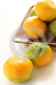 Feshness Japanese orange Mikan on wooden plate