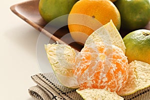 Feshness Japanese orange Mikan on wooden plate