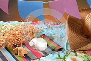 Festa Junina party background with peanuts and traditional sweets. Brazilian summer harvest festival concept. flags and typical photo