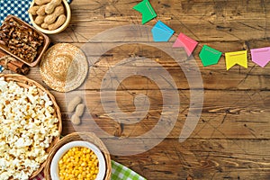 Festa Junina party background with popcorn, peanuts and traditional sweets. Brazilian summer harvest festival concept. Top view,