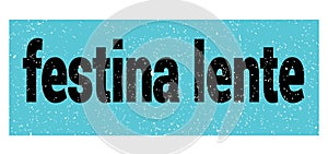 Festina lente text written on blue-black stamp sign photo