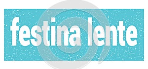 Festina lente text written on blue stamp sign photo