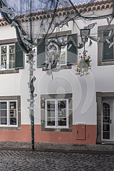 Festival decoration with tinny fishes and traditional house at Camara do Lobos, Madeira