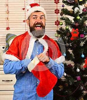 Festivals and presents concept. Man with beard in blue shirt