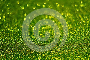 Festive abstract green glitter texture background with shiny sparkle. Colorful defocused background with glittering and sparkling