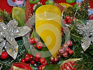 Festive Advent arrangement with yellow candle