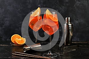 Festive alcoholic cocktail Aperol spritz in glasses on a dark background, concept for bar and New Year\'s Eve, alcoholic