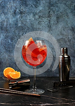 Festive alcoholic cocktail Aperol spritz in glasses on a dark background, concept for bar and New Year\'s Eve, alcoholic