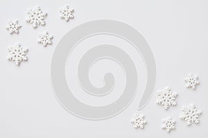 Festive arrangement made of snowflakes on a white background. Flat lay, top view, copy space