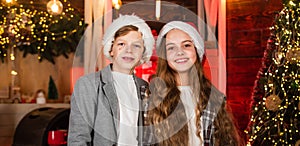Festive atmosphere christmas day. Boy and girl santa claus hats. Closest people. Family celebrate Christmas. Best photo