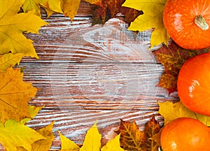 Festive autumn composition with autumn leaves and pumpkins on a wooden background. Flatlay. Top view. Copy space. Banner