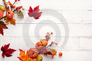 Festive autumn decor from pumpkins, berries and leaves on a white  wooden background. Concept of Thanksgiving day or Halloween.