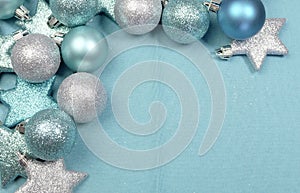 Festive background of aqua pale blue christmas glitter baubles w' copy space