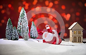 Festive background. Christmas decorations. Santa Claus (or Snowman) standing on snow with beautiful decorated background with