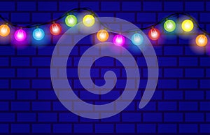 Festive background with colorful lights on a brick wall