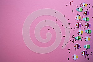 Festive background with cutted out celebration cupcakes paper confetti and vibrant crimson circle glitter