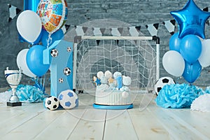 Festive background decoration for birthday with cake, letters saying one and blue balloons in studio, Boy Birthday .Cake Smash