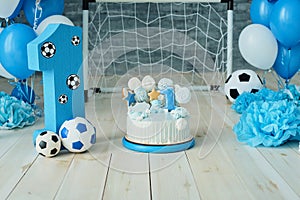 Festive background decoration for birthday with cake, letters saying one and blue balloons in studio, Boy Birthday .Cake Smash