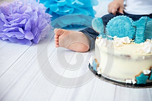 Festive background decoration for birthday with cake, letters saying one and blue balloons in studio, Boy Birthday Cake Smash firs