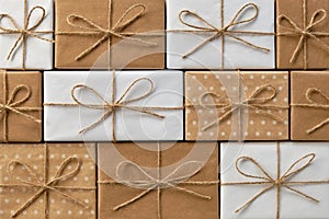 Festive background of gift boxes wrapped in kraft paper