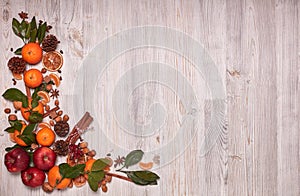 Festive background with mandarins, apples, nuts and spices