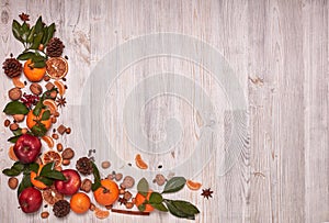 Festive background with mandarins, apples, nuts and spices