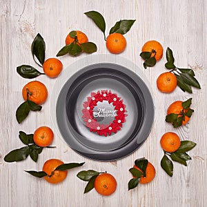 Festive background from mandarins and plate. Christmas background