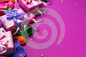 Festive background of purple material colorful balloons streamers confetti three boxes gift Top view flat lay copy space