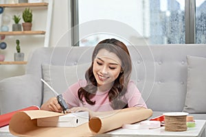 Festive background. Top view composition of woman hands wrap present for Birthday, Mother`s day, Valentine`s Day, March 8. Packe