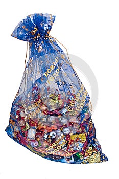 Festive bag full of sweets and candies on white background