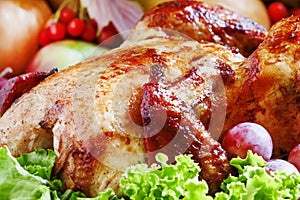 Festive baked chicken with autumn berries, fruits, nuts and vegetables in the rustic style of the old wooden