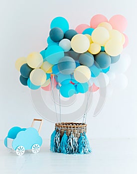 Festive balloons with basket on white background. Congratulations on the newborn