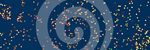 Festive banner, background with small multicolored holographic sparkles on dark blue background. Christmas, New Year or