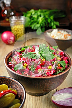 Festive beetroot salad vinaigrette in a clay bowl