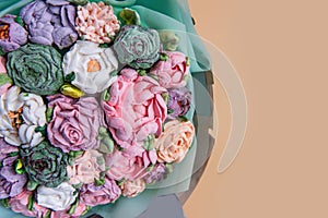 Festive bouquet of sweet sugar marshmallow rose flowers on beige isolated white background