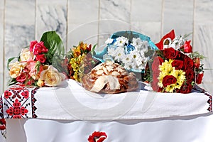 Festive bread with bouquets of flowers on the table