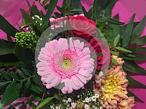 Festive bunch of flowers with pink flower head and red roses
