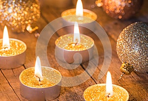 Golden Advent candles with glittering christmas balls