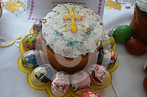 A festive cake is decorated with a cross of dough