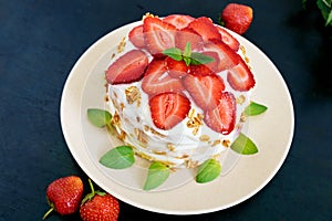 A festive cake with fresh strawberries, cream, decorated with mint leaves