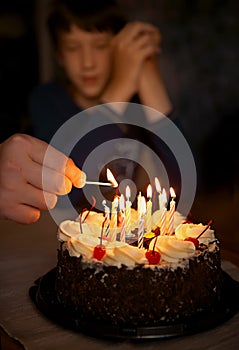 Festive candles are lit on the birthday cake