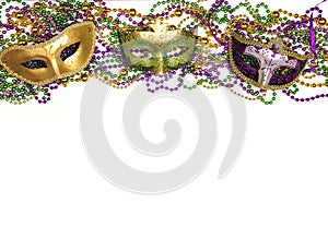 Festive Carnival background with masks, beads and copy space