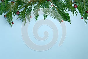 Festive Christmas background with fir twigs, red christmas decorations
