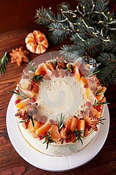 Festive Christmas cake decorated with fruits and rosemary