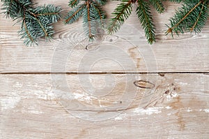 Festive Christmas decoration, fir and spruce twigs on a rustic wood background