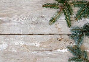 Festive Christmas decoration, fir and spruce twigs on a rustic wood background