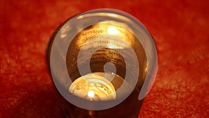 Festive Christmas decoration with tea light in a glass on a red table in Fulda, Germany.