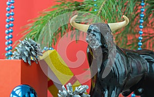 Festive Christmas decorations on a red background. bull as a symbol of the new year 2021. xmas beads