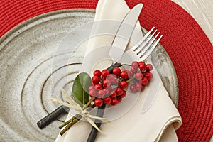 Festive Christmas dinner table setting place setting with natural botanical decorations