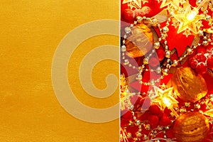Festive Christmas golden background with red Xmas Decorations. Creative mock up for greeting card, party invitation